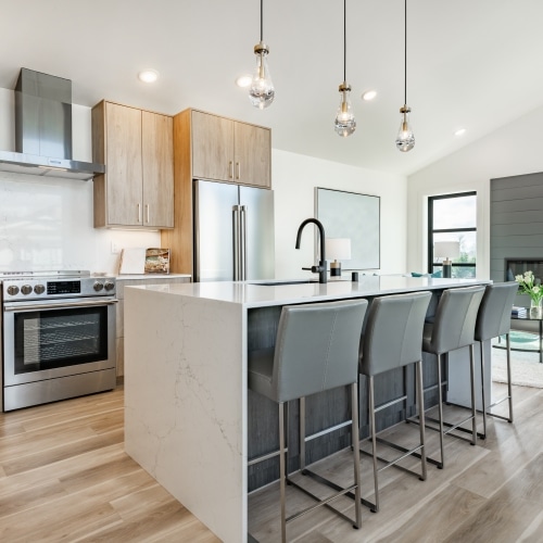 modern kitchen and family room with a island and a chic built in six foot long rectangular inset fireplace