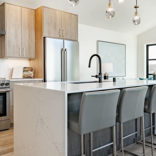 modern kitchen and family room with a island and a chic built in six foot long rectangular inset fireplace