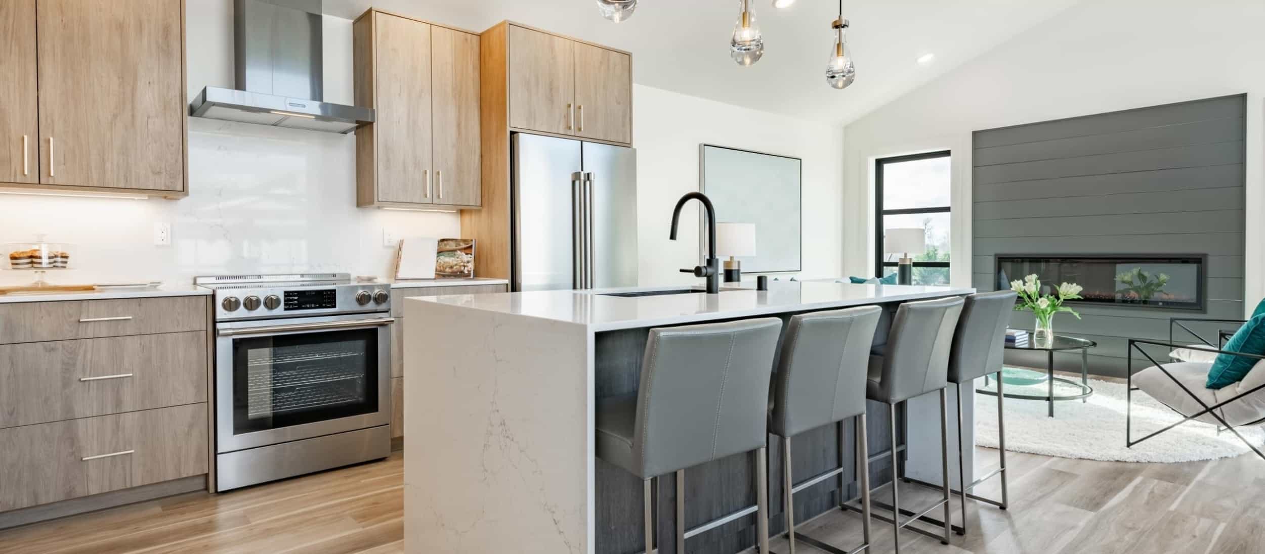 modern kitchen and family room with a island and a chic built in six foot long rectangular inset fireplace